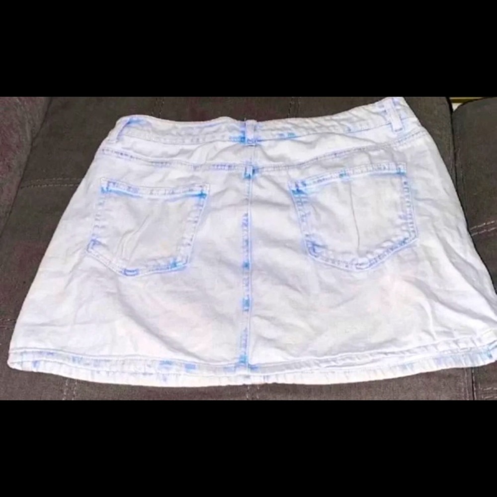 A damaged light blue denim skirt size medium.